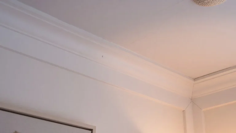 Simple bed molding trim along a bedroom ceiling corner