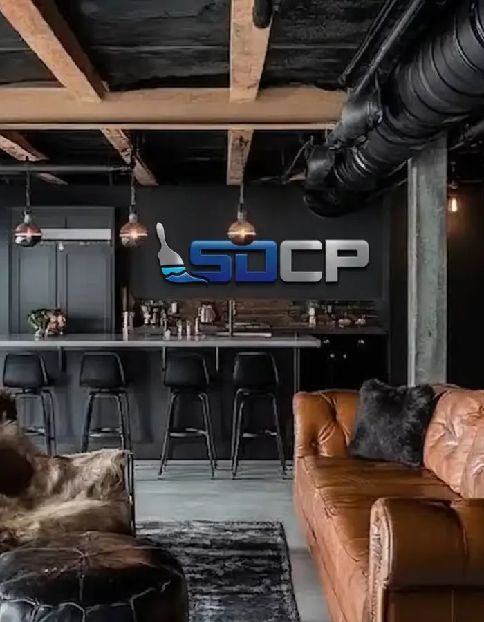 A black ceiling helps exposed ductwork, pipes, and structural elements blend into the background while supporting a clean industrial style design.