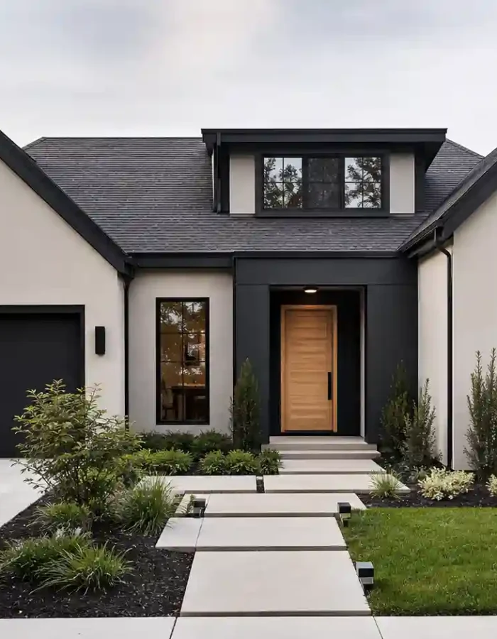 Warm white walls, bold black trim, and a natural wood door create a clean, modern look that still feels warm and welcoming.