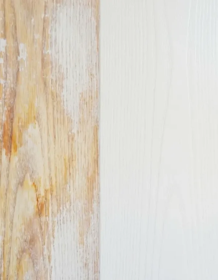 Brown and yellow stain bleeding through a white painted wood surface.