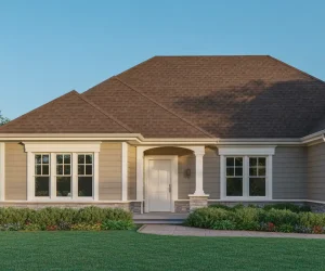 A beautiful example of warm beige siding paired with a brown roof, white trim, and natural stone accents creating excellent curb appeal.
